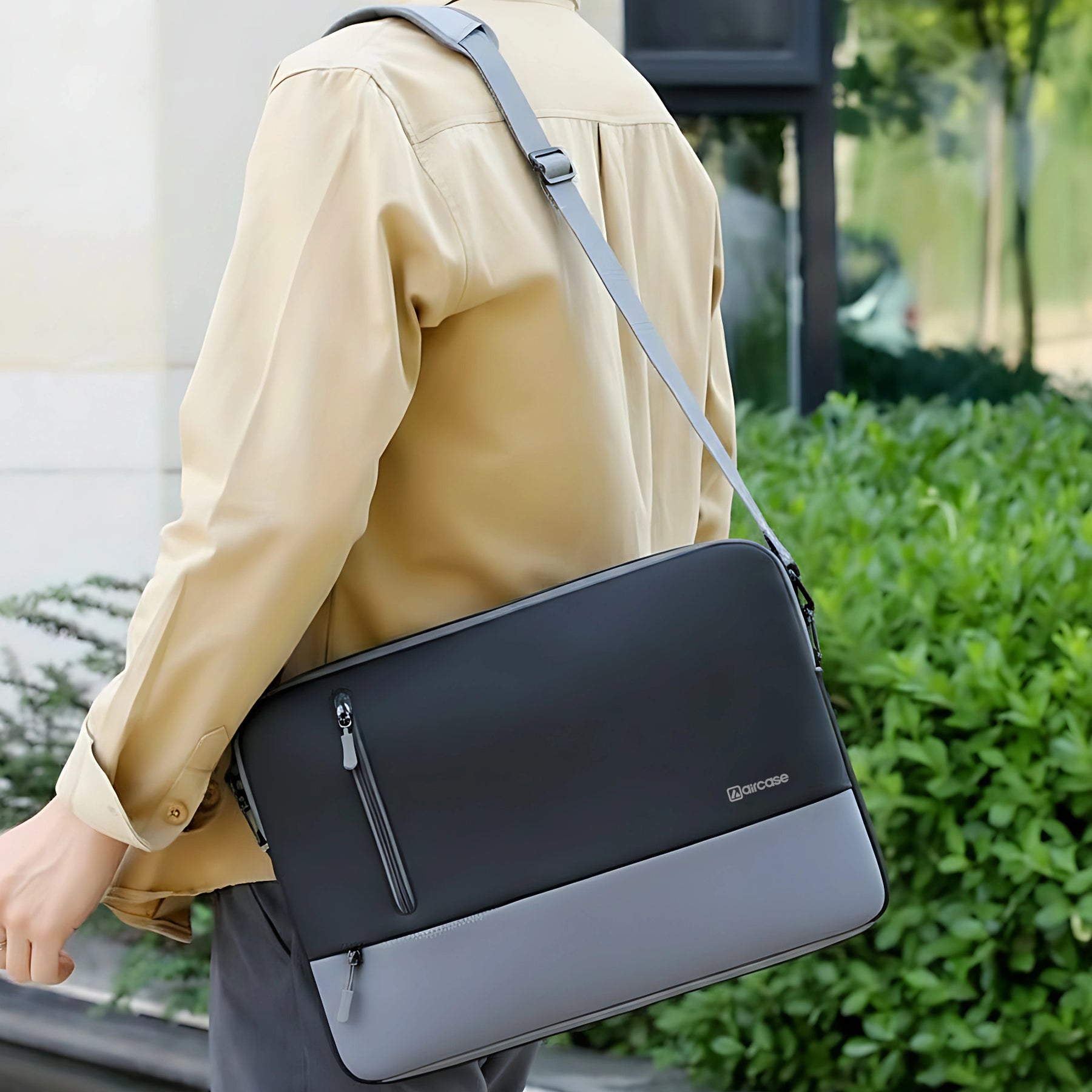 AirCase 13.3-inch laptop sleeve with shockproof foam, water-resistant PU leather, front pocket, luggage belt, and premium zipper