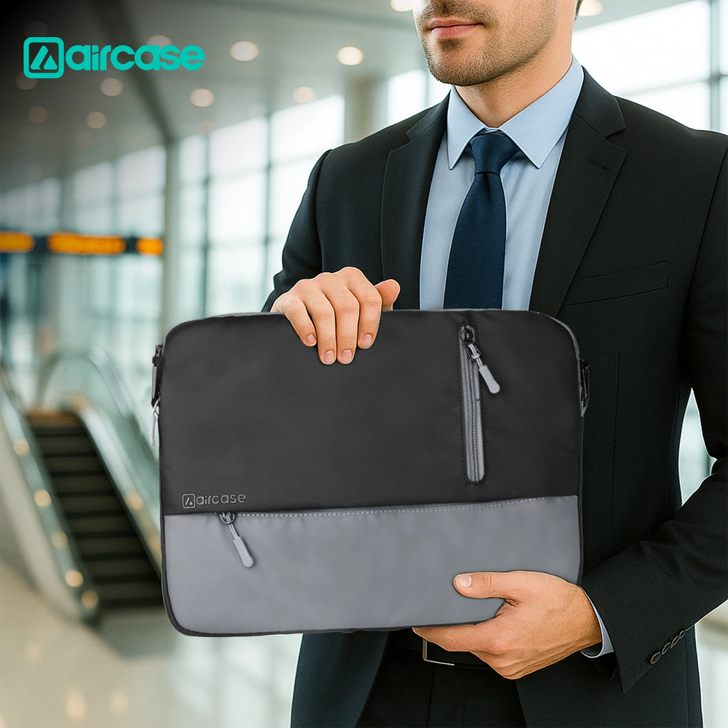 AirCase 13.3-inch laptop sleeve with shockproof foam, water-resistant PU leather, front pocket, luggage belt, and premium zipper